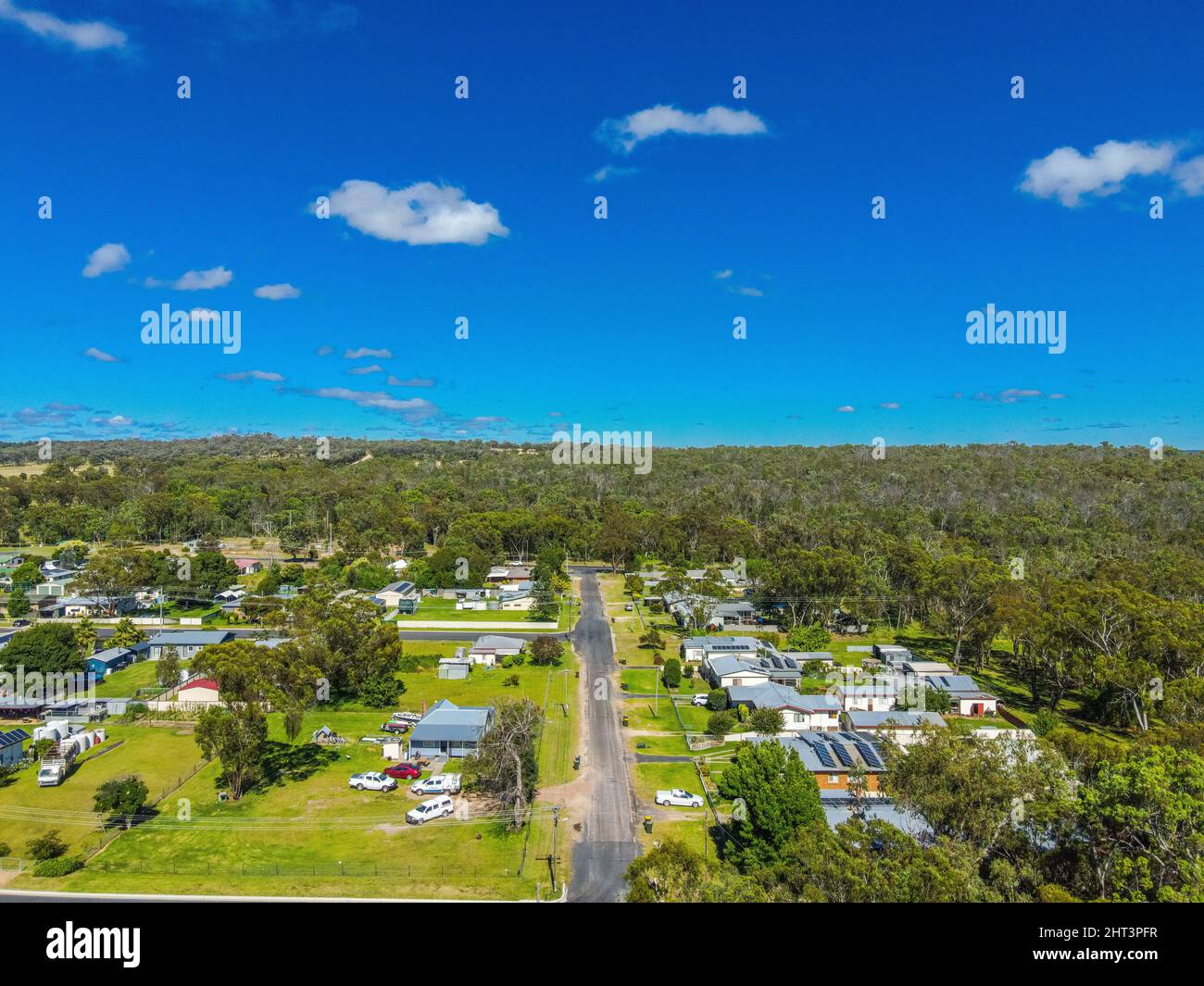 Aerial View of the town of Gilgai surrounded by green rainforests in