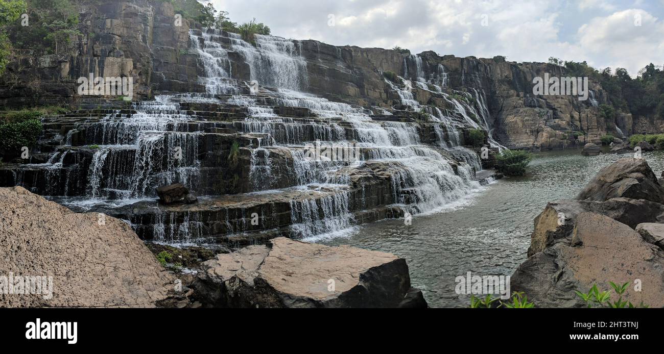 Scenic falls cascading over several levels of rocks, set amidst ...