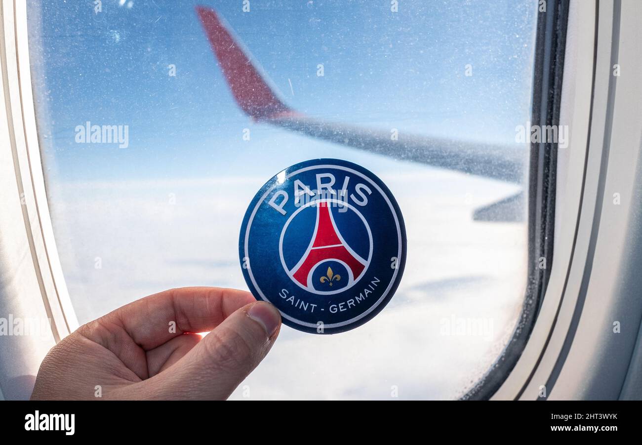 December 6, 2021. Paris, France. The emblem of the Paris Saint-Germain F.C. football club on the background of an airplane window. Stock Photo