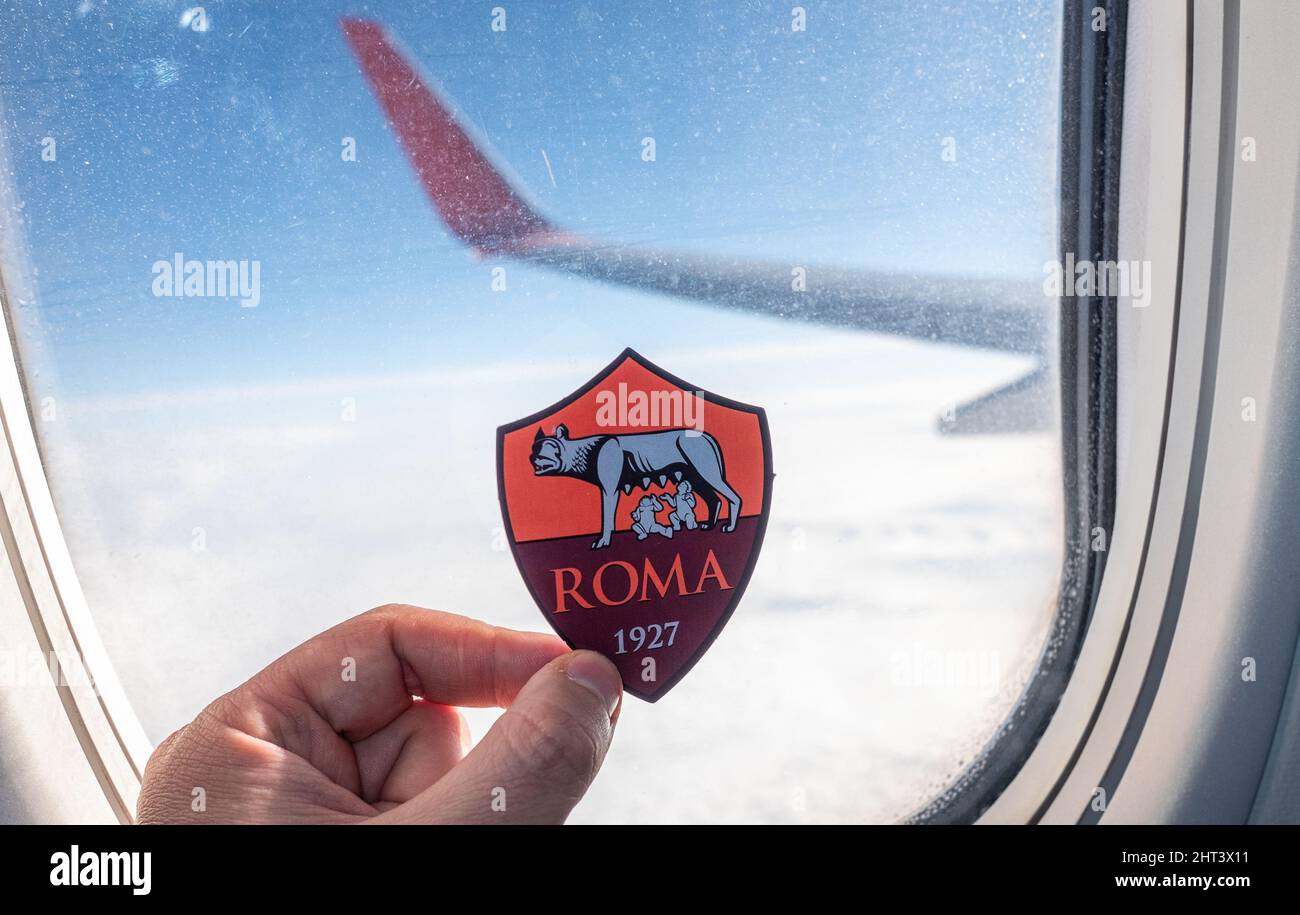 December 6, 2021. Rome, Italy. The emblem of the football club A.S. Roma on the background of the airplane window. Stock Photo