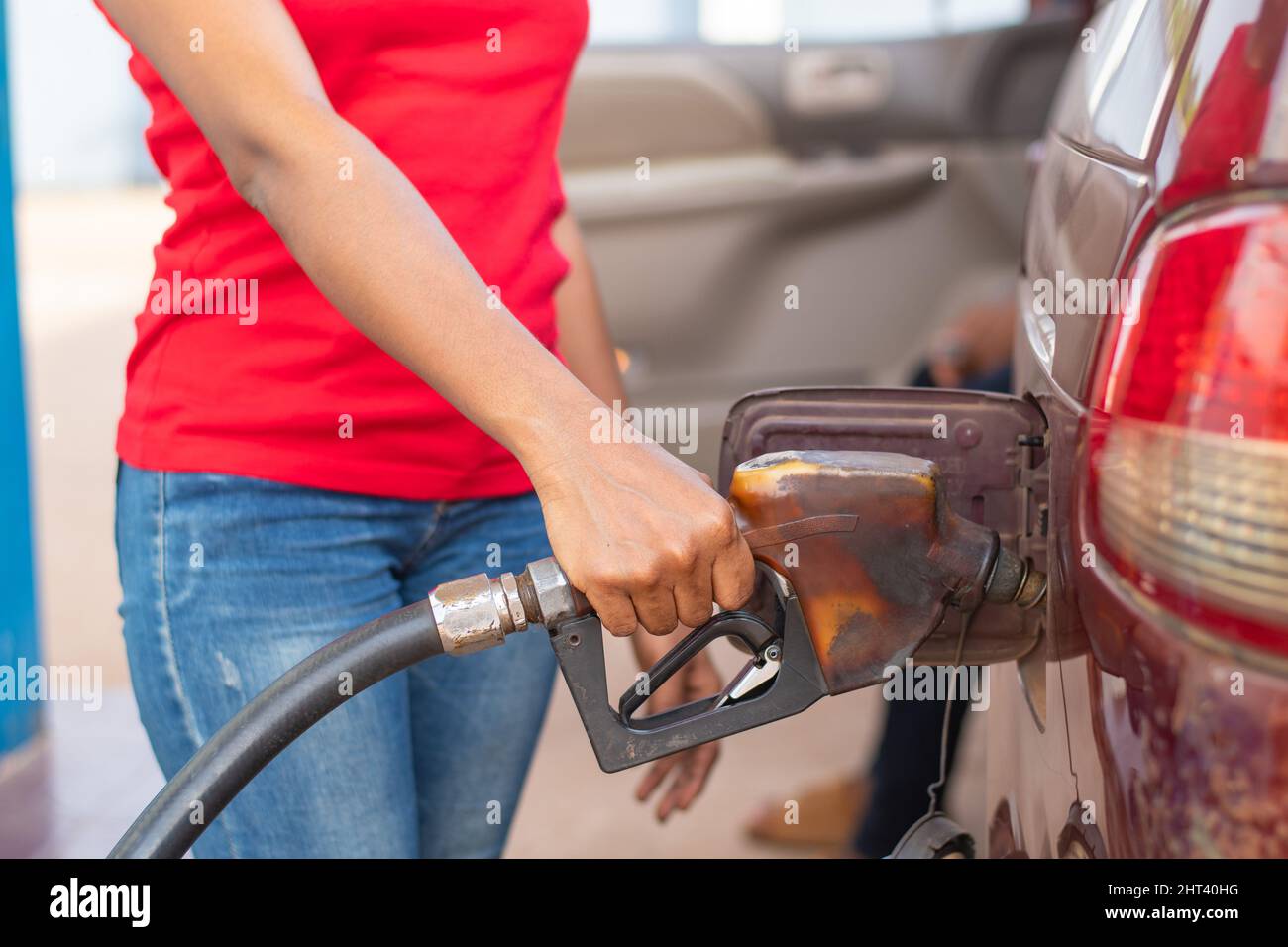 African petrol station attendant filling up a car Stock Photo - Alamy