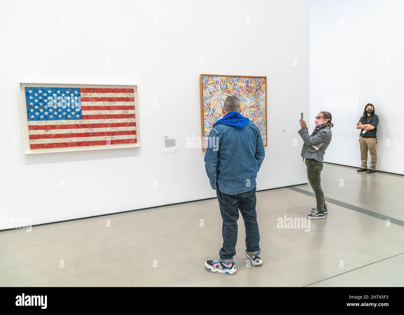 Los Angeles, CA, USA - February 25, 2022: A visitor takes a picture of the painting “Flag” by artist Jasper Johns at the Broad Museum in downtown Los Stock Photo