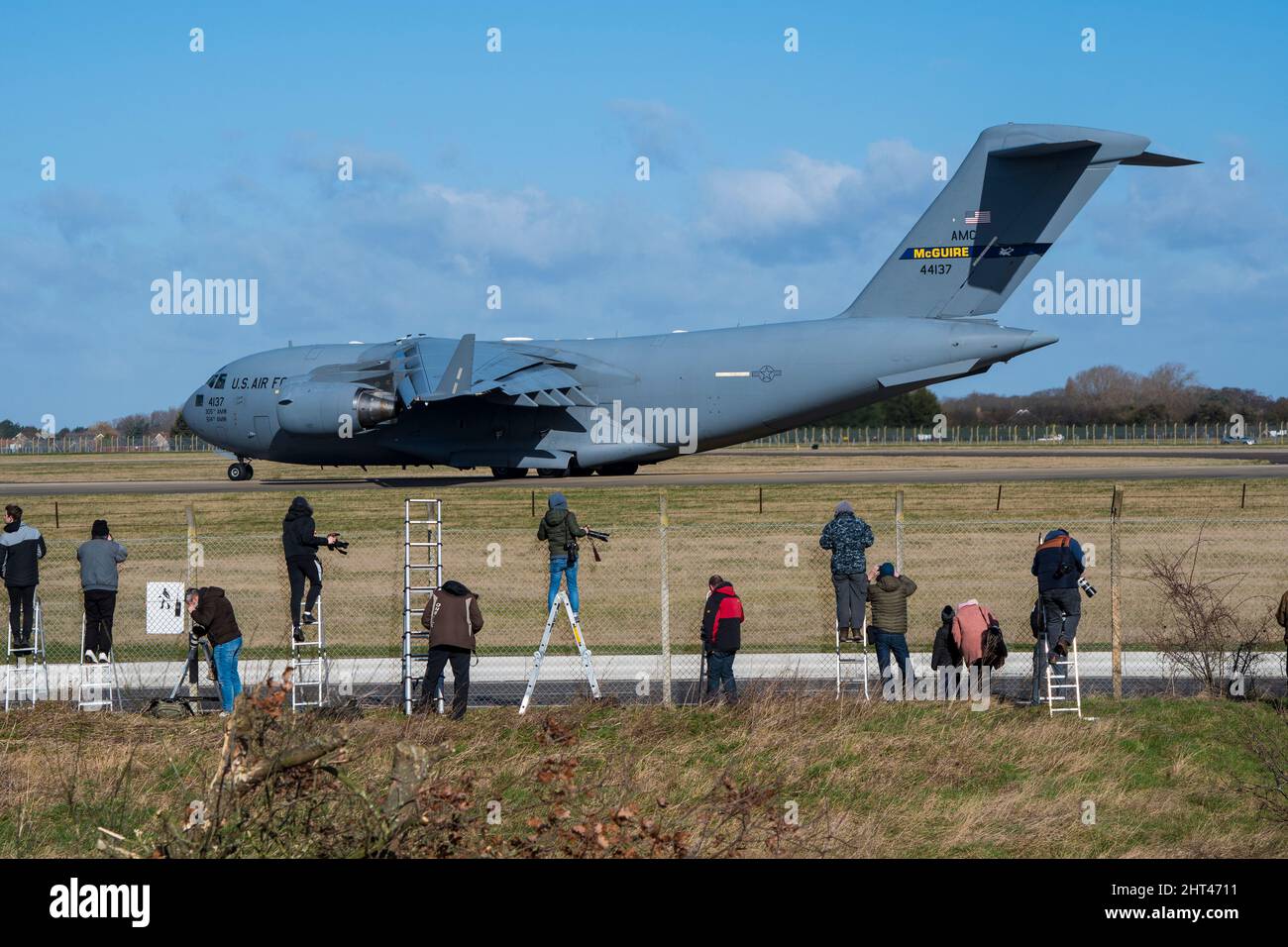 Plane spotters at Mildehall Air Field taking pictures of Boeing C-17 Globemaster III taxi-ing Stock Photo