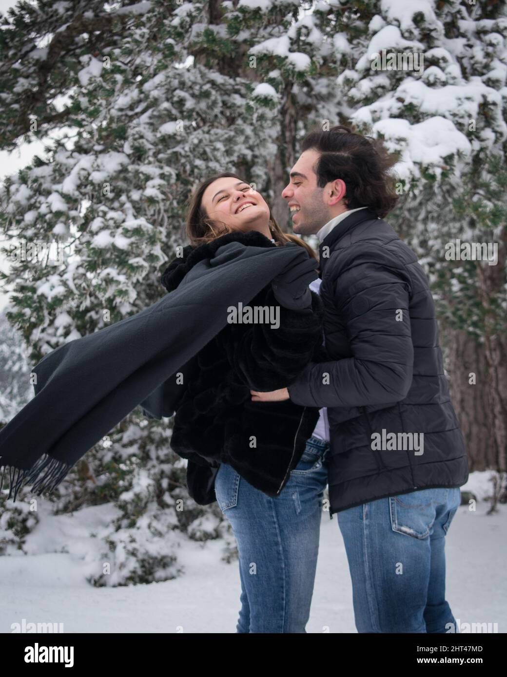 Happy young couple having fun together in the winter park Stock Photo ...