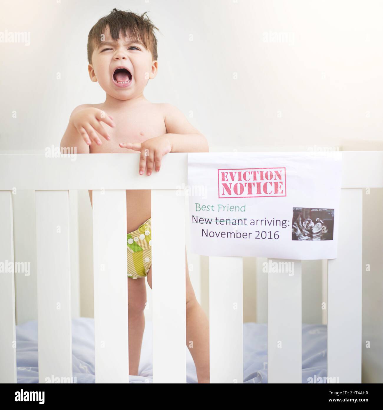 Dont I get a say. Shot of an unhappy baby boy crying while standing in his crib. Stock Photo