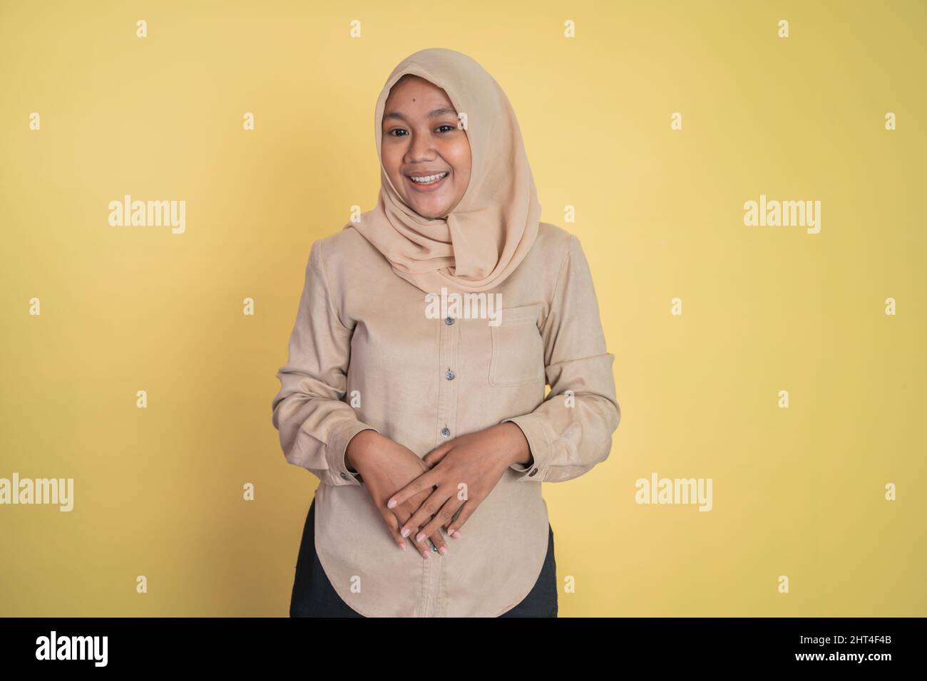 Asian woman in hijab smiling while looking at camera Stock Photo - Alamy