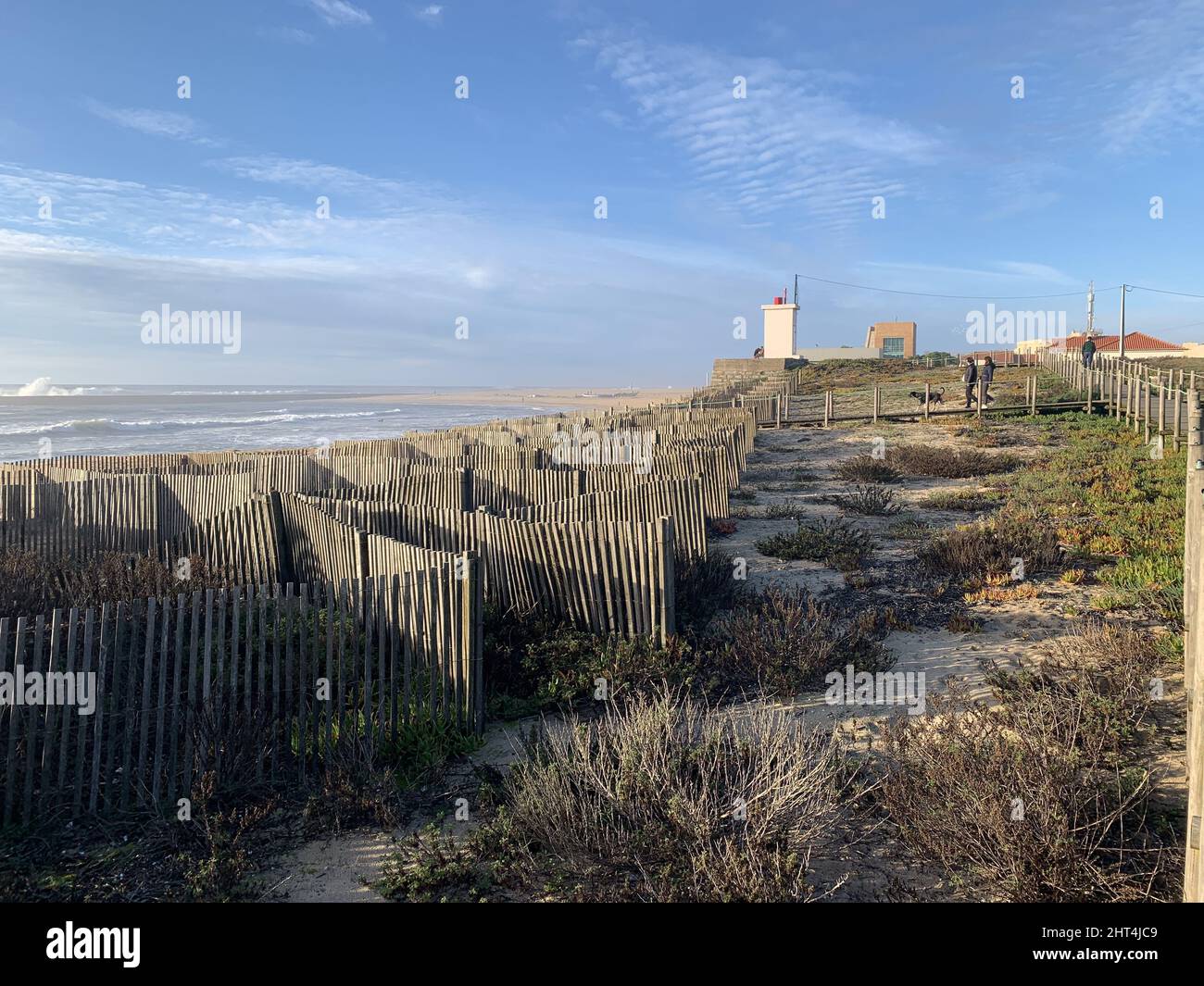 Wooden fence on the beach during sunset Stock Photo - Alamy