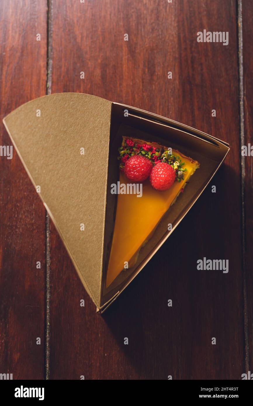 Top view of a mango cheesecake with raspberries in a cake box Stock ...