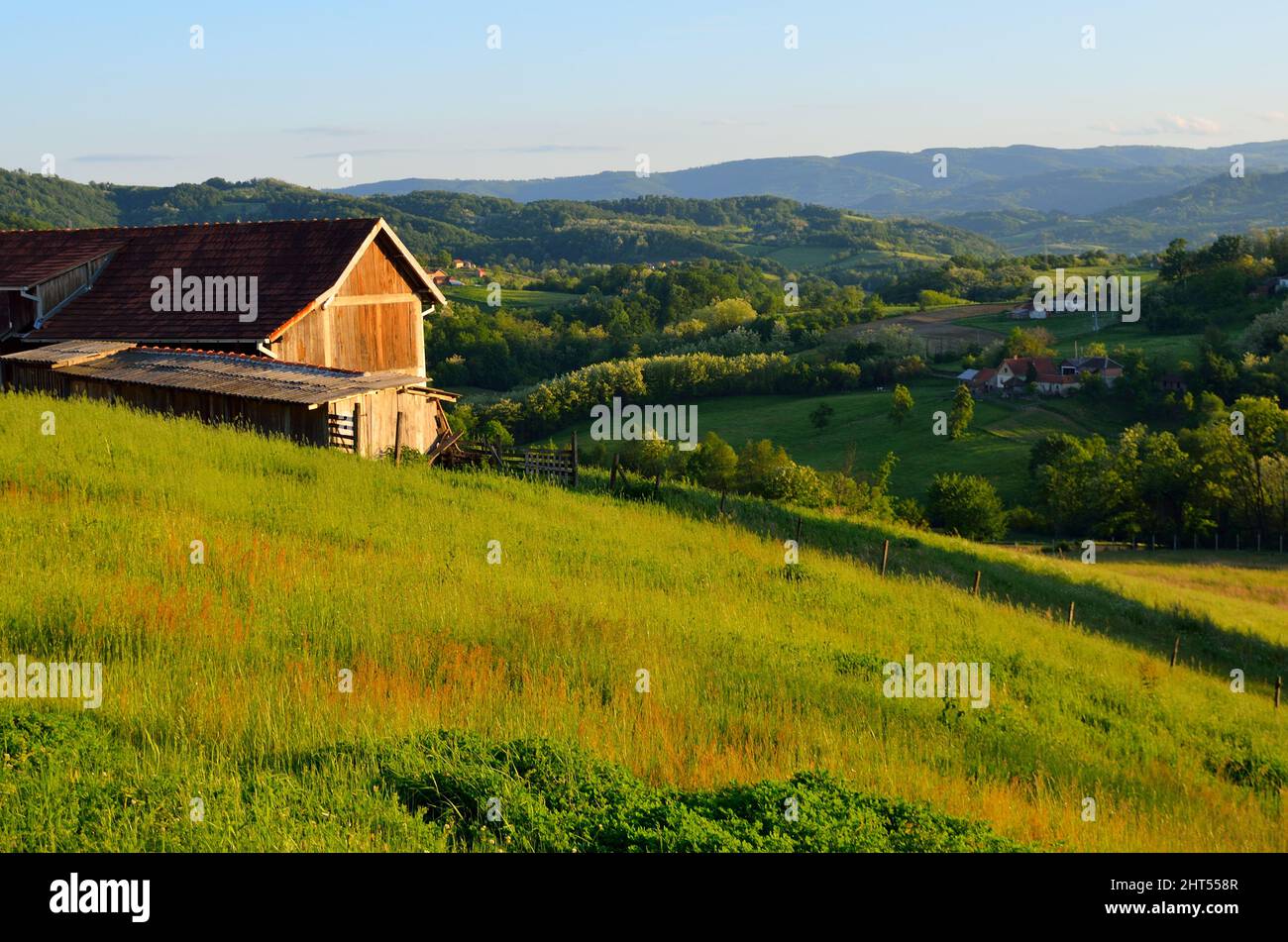 Landscape of a wooden house with greenery on a hilly terrain Stock ...