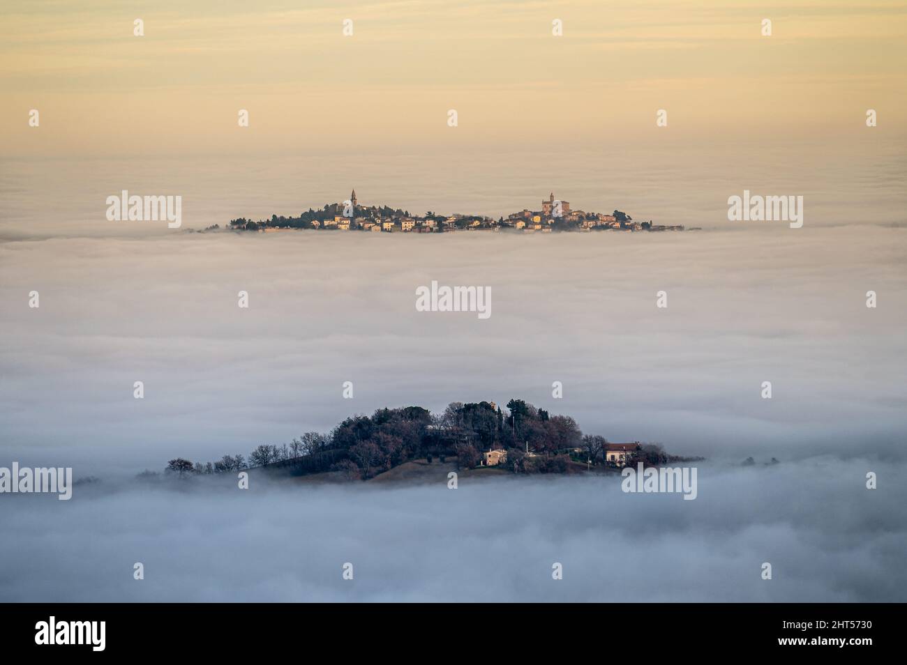 View of the medieval village of Montecarotto di Arcevia immersed in the fog Stock Photo