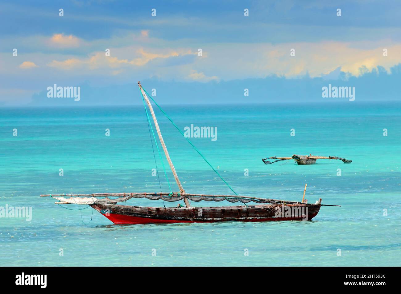 A wooden sailboat  (dhow) on the clear turquoise water of Zanzibar, Tanzania Stock Photo