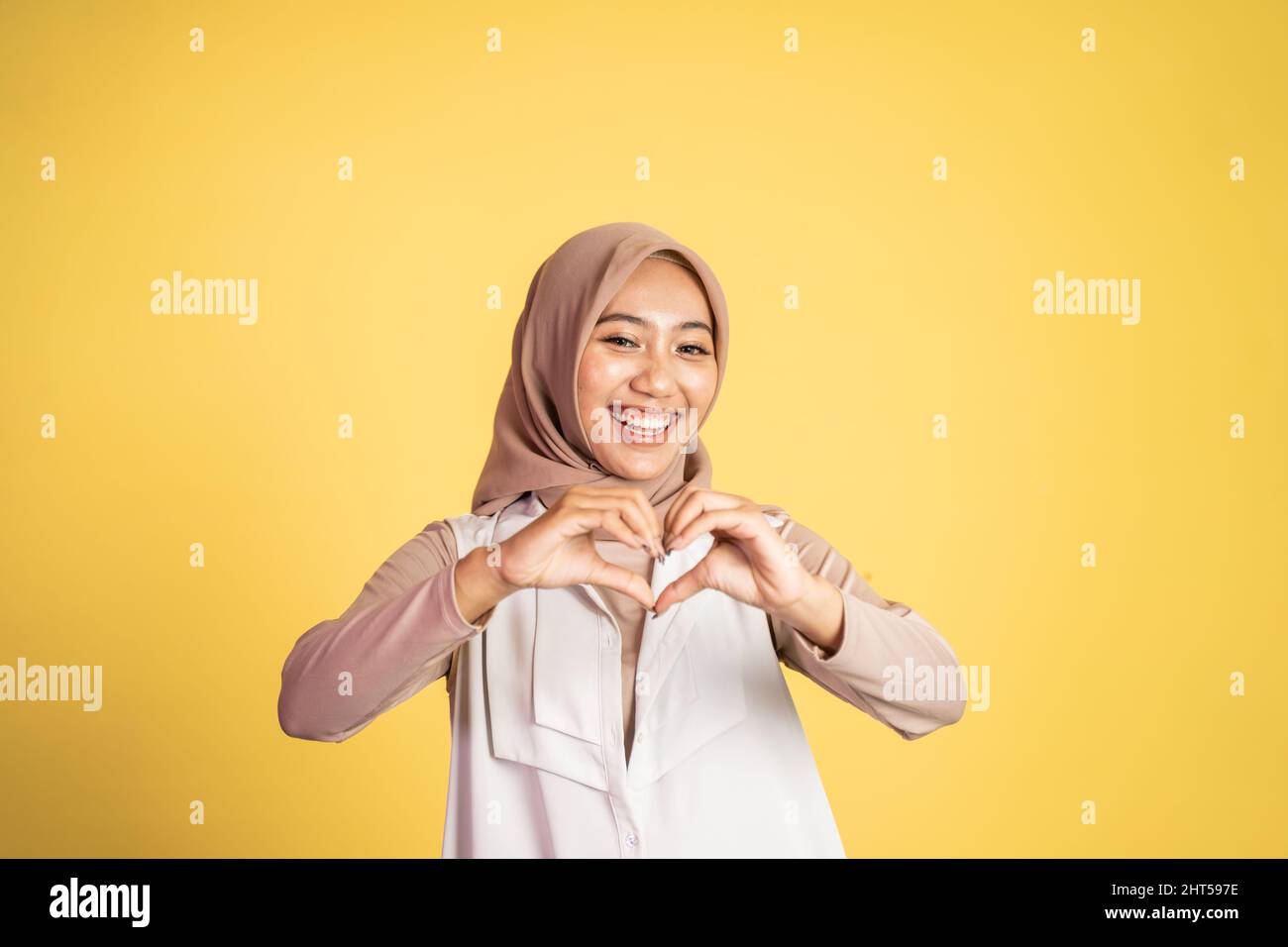 happy muslim woman making love shape gesture Stock Photo - Alamy