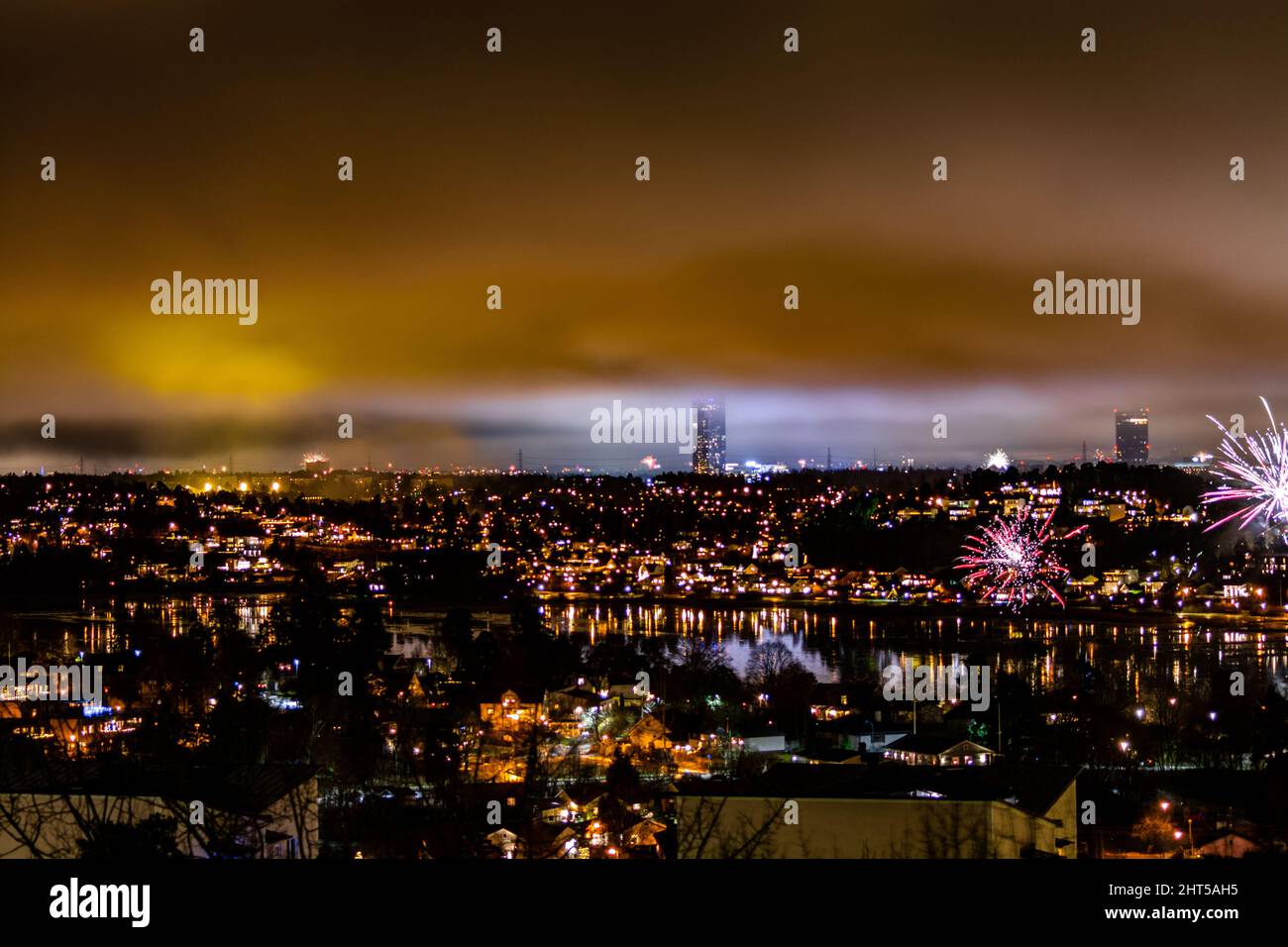 Breathtaking cityscape with fireworks and golden lights at night undear ...