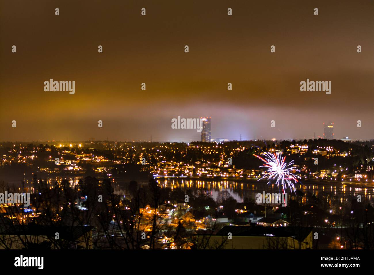 Breathtaking cityscape with fireworks and golden lights at night undear ...