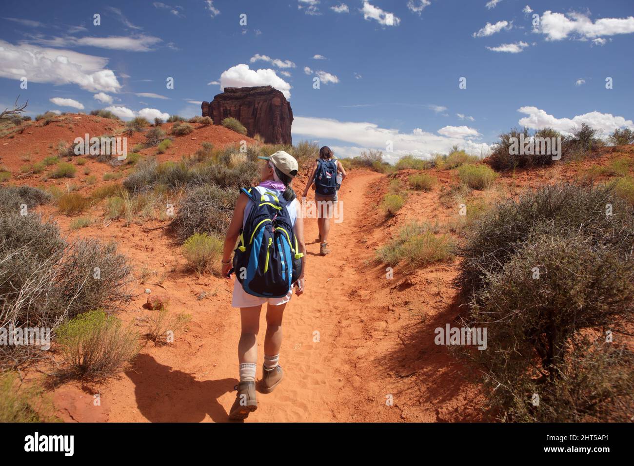 Hiking the Wildcat Trail in Monument Valley Navajo Tribal Park, USA. A hot august day with blue sky and sandstone cliffs, buttes, and pinnacles. West Stock Photo