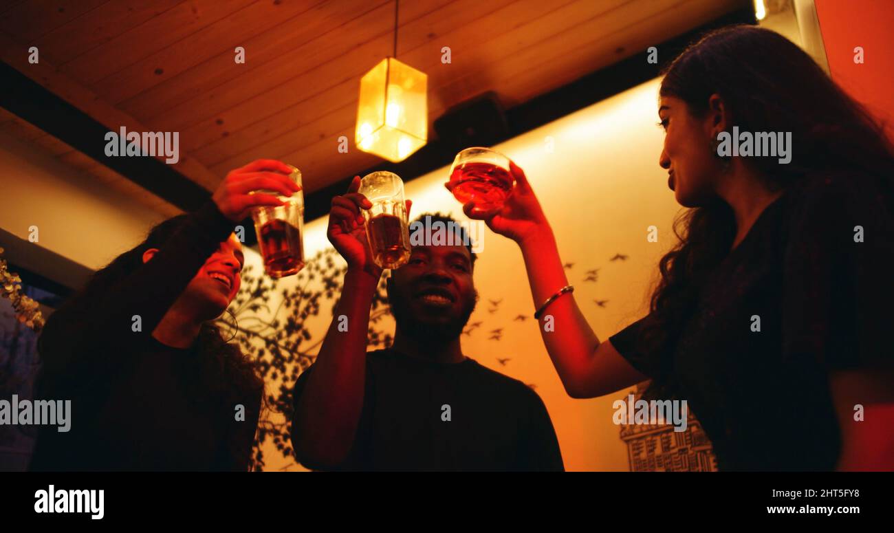 Group of South Asian friends cheering at a party - friendship concept ...
