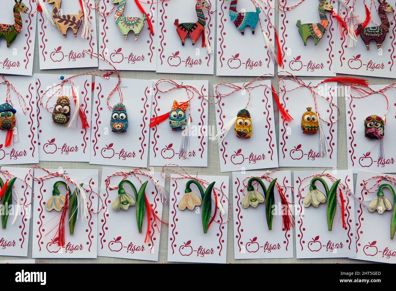 Bucharest, Romania. 26th Feb, 2022. Small handmade figurines called 'Martisor' are displayed during the 'Martisor Fair' in Bucharest, capital of Romania, Feb. 26, 2022. Martisor is a small decoration tied with a red-and-white twisted string, given to women on the 1st of March as a token of appreciation, love or friendship and as a wish of health, being at the same time a symbol of the coming spring. Credit: Cristian Cristel/Xinhua/Alamy Live News Stock Photo