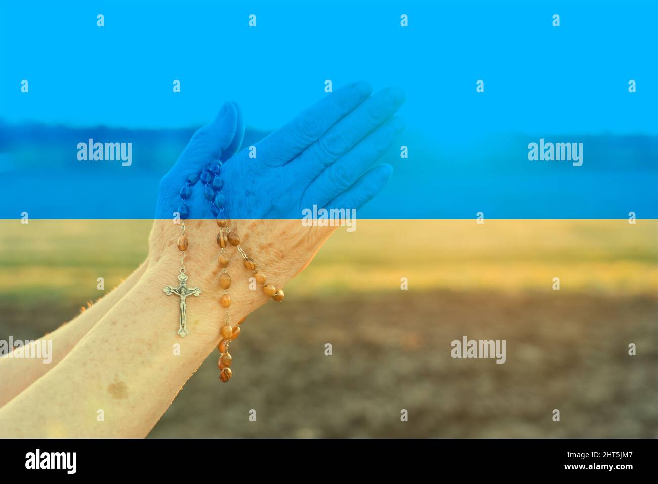 pray for ukraine war concept with flag overlay Stock Photo