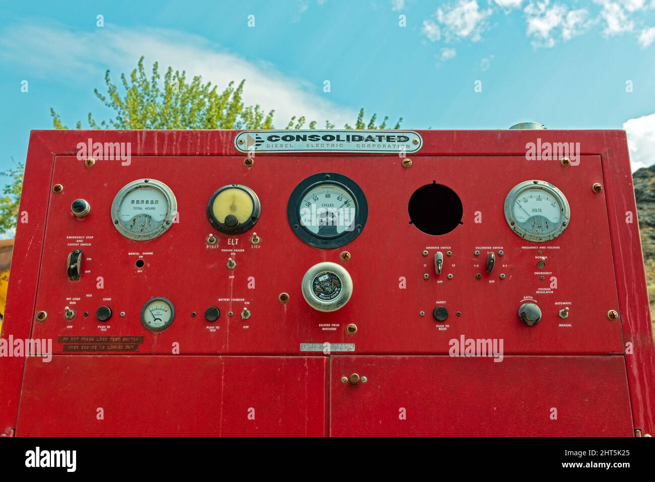 The control panel for a vintage diesel electric generator in a junkyard