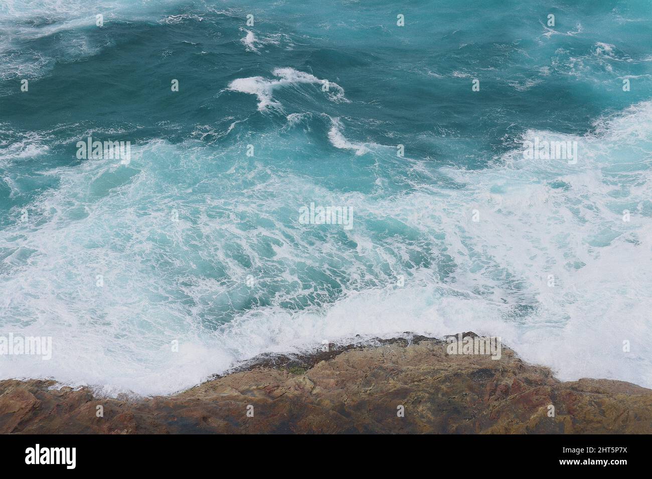 Shot of waves crashing into a rocky coast Stock Photo - Alamy