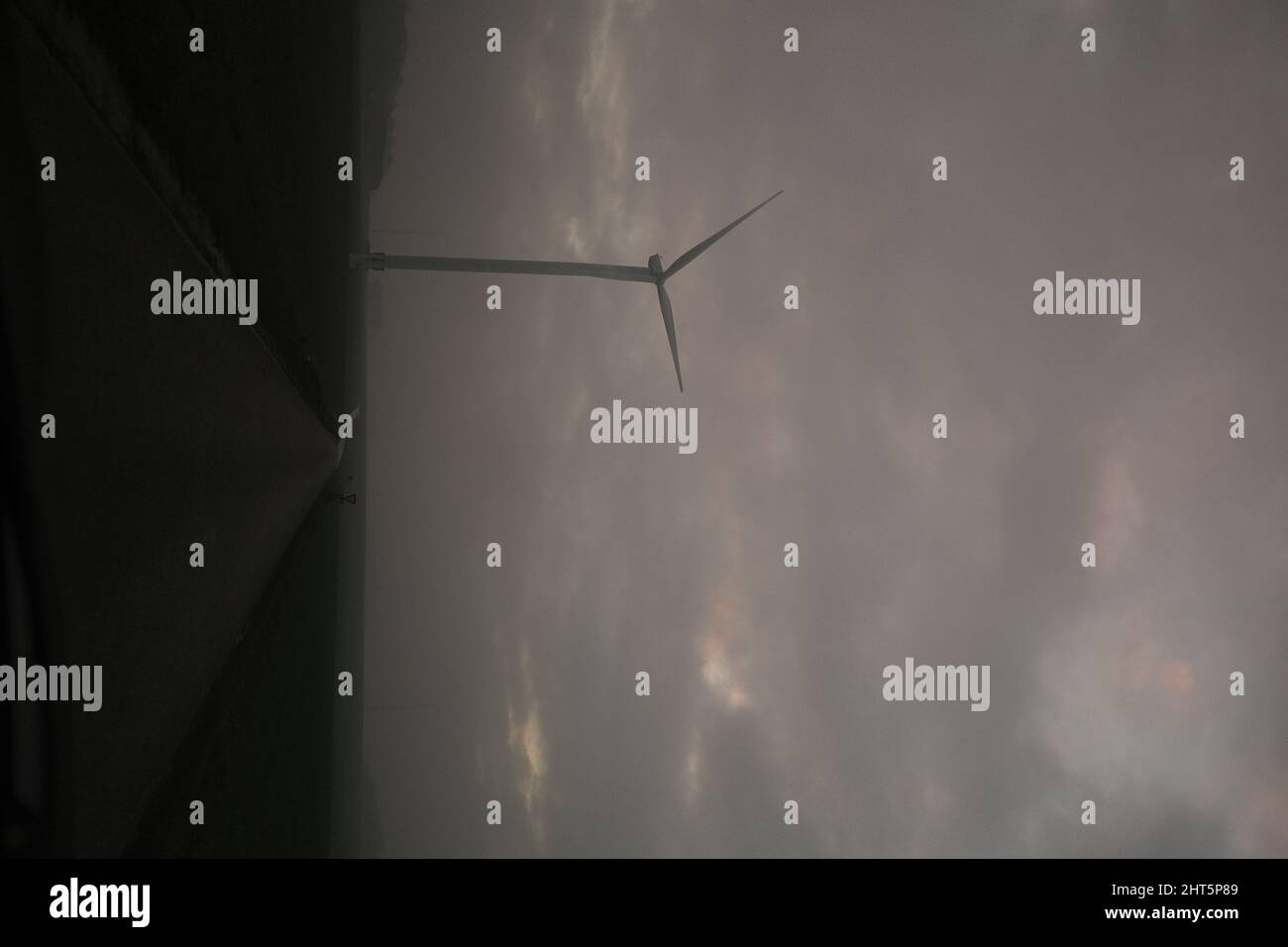 Closeup of a wind turbines with cloudy sky background Stock Photo - Alamy