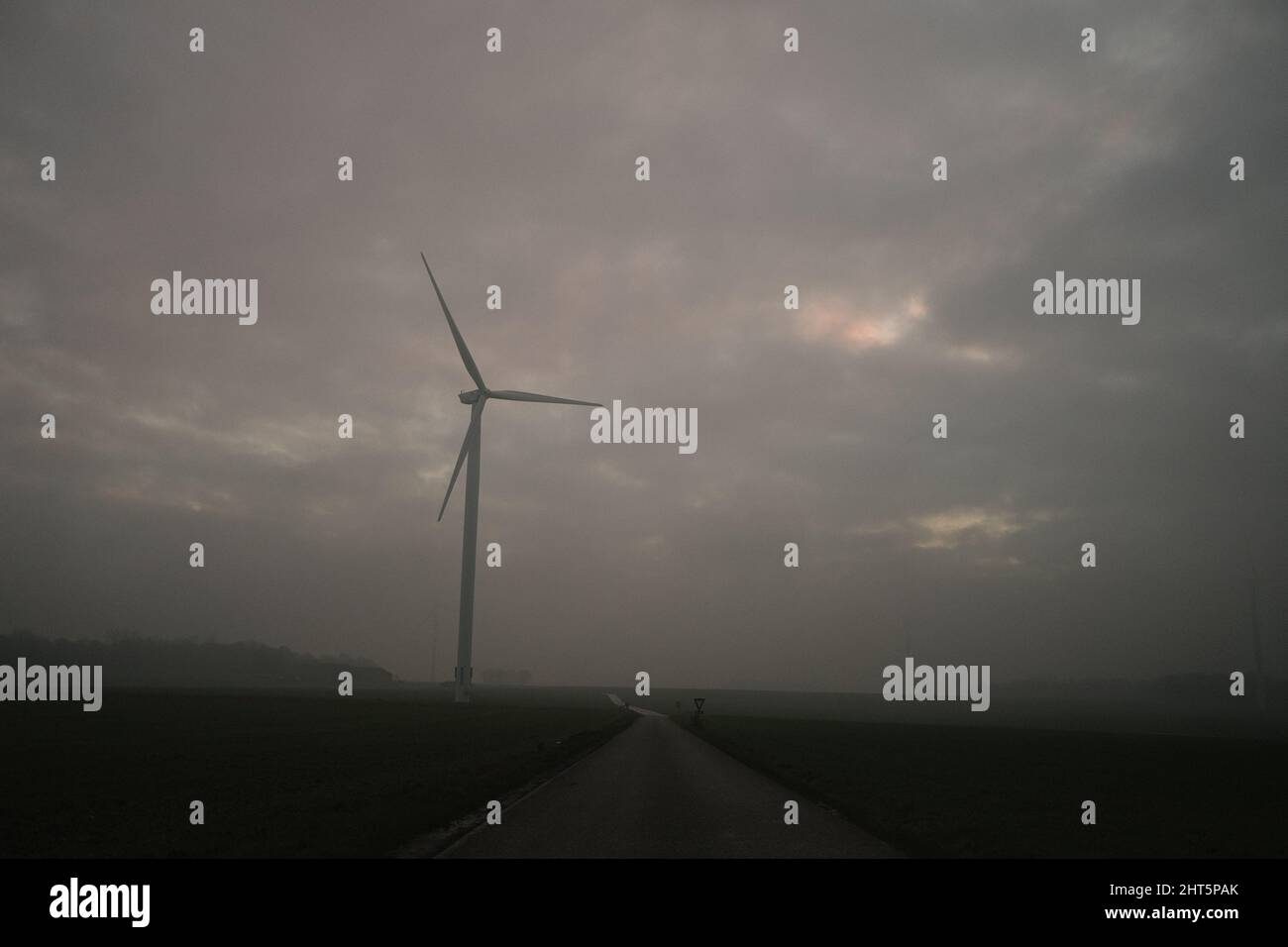 Closeup of a wind turbines with cloudy sky background Stock Photo - Alamy
