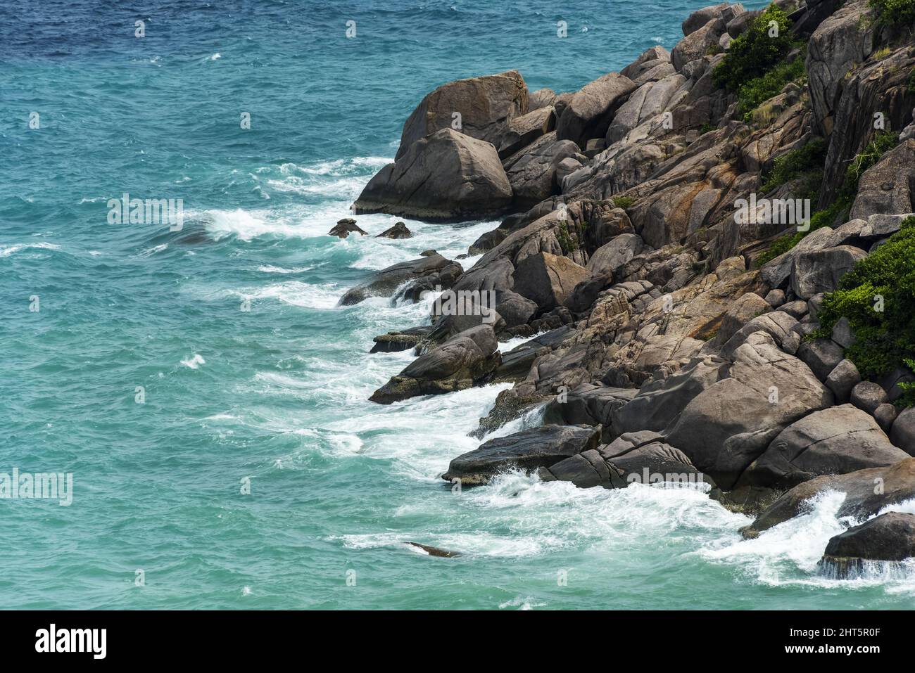 Aerial view of the waves splashing on the coastal rocks in Koh Nang ...