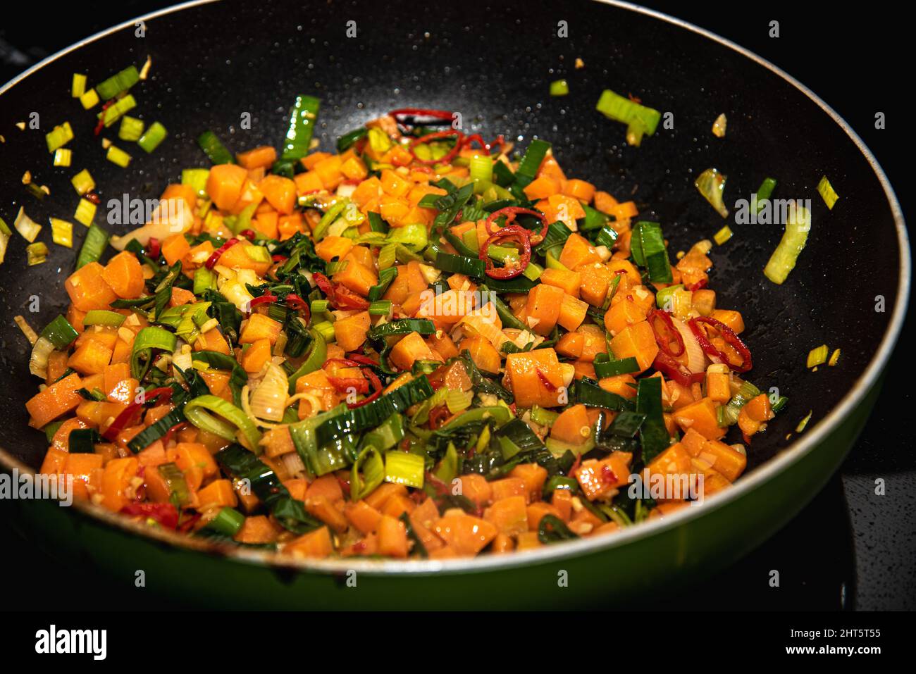 Pan with small cut vegetables and spices Stock Photo - Alamy