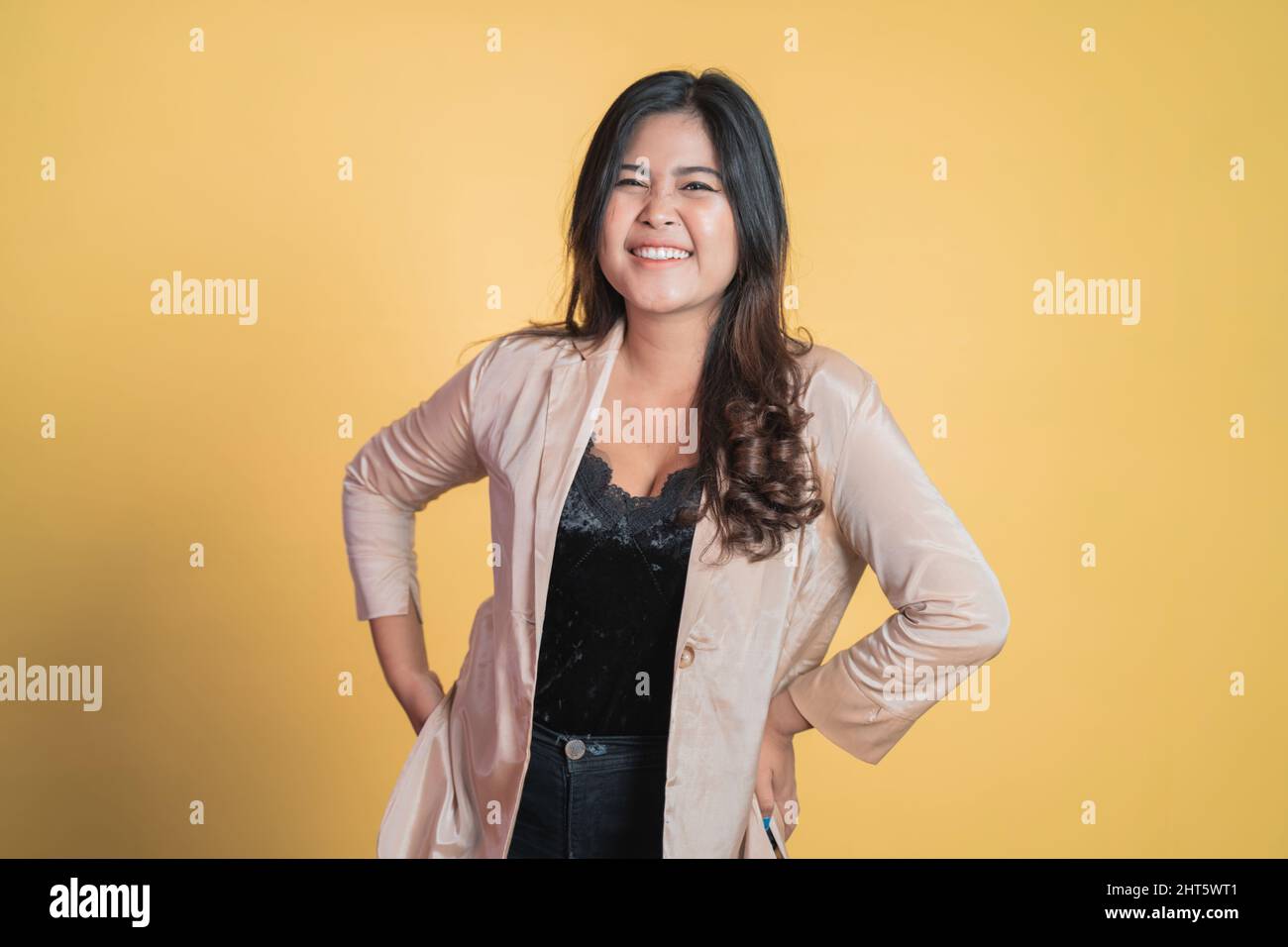 young asian woman standing with hands on waist Stock Photo - Alamy