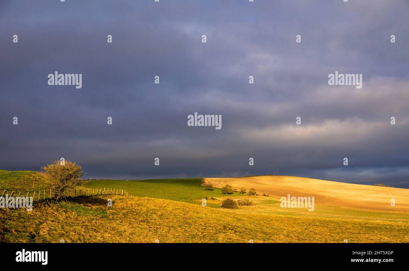 Sunlight and storm clouds along Smeathes ridge near Barbury Castle on ...