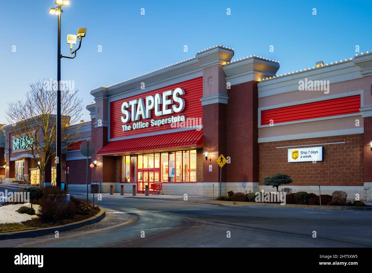 New Hartford, New York - Feb 24, 2022: Closeup Night View of Staples The Office Superstore Building Exterior. Staples Inc. is a US Office Retailer Stock Photo