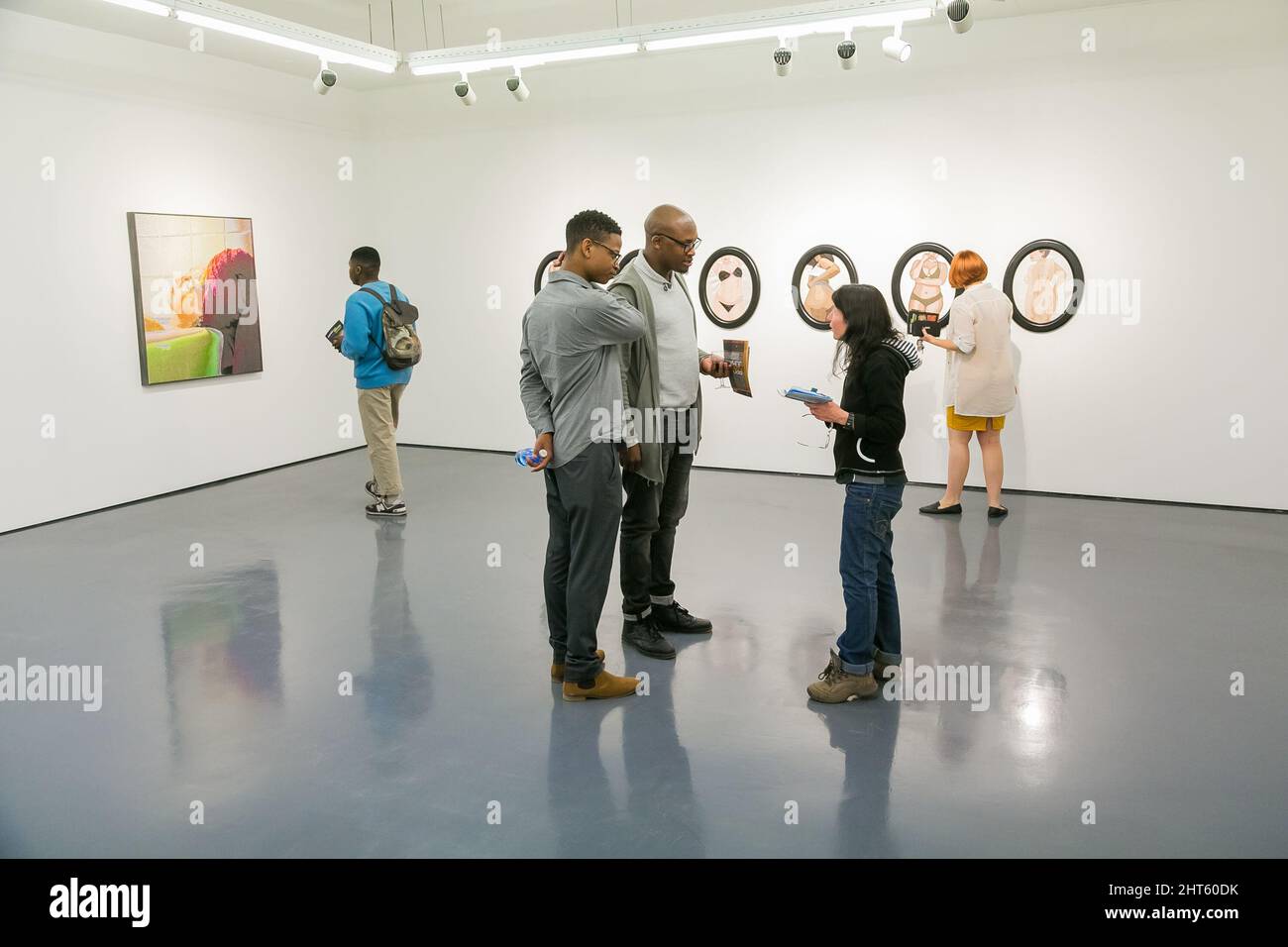 Visitors viewing art exhibit in gallery in Johannesburg, South Africa