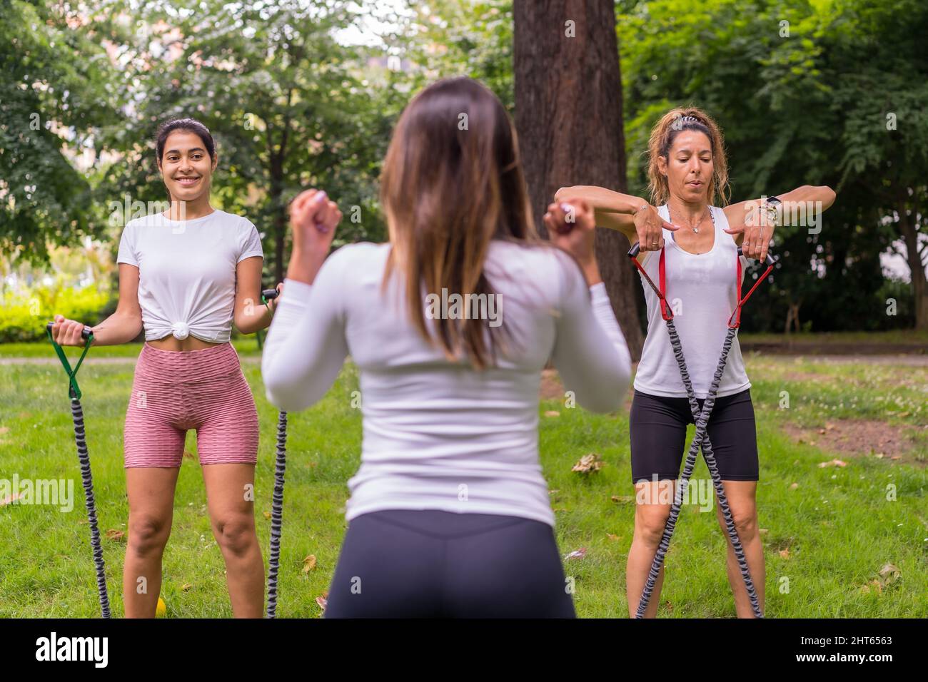 Group of young women exercising in a park on a sunny day Stock Photo ...