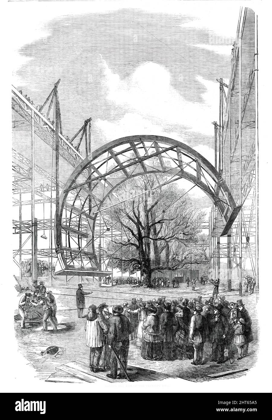 The Great Exhibition Building in Hyde Park - Raising the Ribs of the Transept Roof, 1850. 'The extraordinary resources of the contractors of the &quot;Crystal Palace&quot; have had no fitter occasion for their display than in the setting up of the massive circular ribs for the roof of the transept. Prince Albert, on his visit last week, specially witnessed, with great and acknowledged interest, the operation of raising and fixing a pair of them. About three quarters of an hour was occupied ere they were securely deposited in their places. Only two now remain of the whole number forming the tra Stock Photo