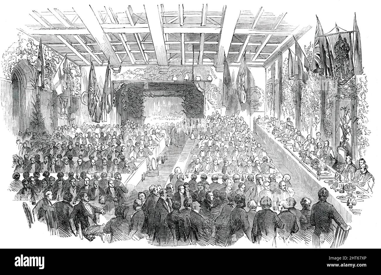 Banquet given by the Mayor of Southampton to the Lord Mayor and Sheriffs of London, 1850. Dinner given by Richard Andrews, Mayor of Southampton in Hampshire, '...to celebrate the successful progress in South Hants of public feeling in favour of the Great Industrial Exhibition ot 1851'. The banquet took place in Southampton Town Hall, of which '...both the interior and exterior were fitted up magnificently...On the tables were vases filled with flowers, and the top of the hall was wreathed with flowers and evergreens...The judicial bench formed a dais at which the principal guests sat'. Many to Stock Photo