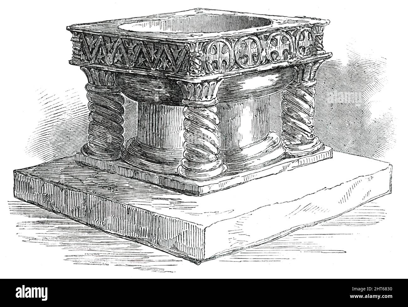 New Font for Easton Church, near Winchester, 1850. Stone font for St Mary's Church, '...executed entirely by the hands of a lady, also resident in the parish. It is of Caen stone, the design being taken from the well-known old font in New Shoreham Church, which, bearing the characteristics of the late Norman, was appropriately selected for the model. It is 2 feet 9 inches square, and has a massive centre pillar and four spiral shafts; the sides have each a different pattern, deeply cut; the stopper is of bronze, in the form of a laten cross. The artiste of this valuable gift was employed somew Stock Photo