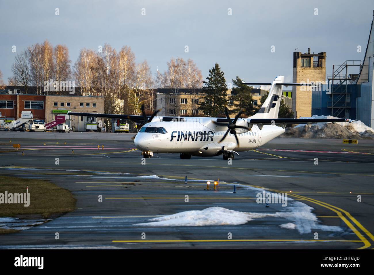 15-01-2022 Riga, Latvia White Passenger plane fly up over take-off runway from airport Stock Photo