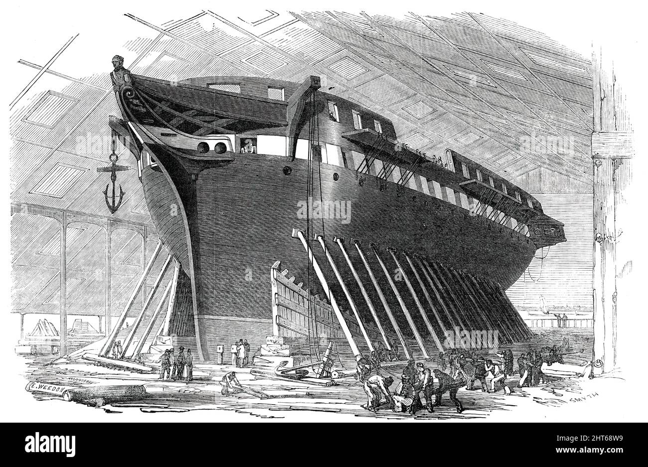 H.M. 50-Gun Frigate &quot;Nankin&quot;, to be launched this day, Saturday, 1850. 'This noble and beautiful specimen of naval architecture...is built from the designs of Mr. O. U. Lang, the assistant shipwright at the Royal Dockyard [in Woolwich, London]...A considerable space has been fitted up as booths on both sides and under the bows of the vessel...to afford the friends of the Admiralty and the authorities...a fine view of the launch. The figure-head is a representation, carved by Mr. Hellyer, of Vice-Admiral Sir William Parker...Commander-in-Chief of the fleet at present assembled on the Stock Photo