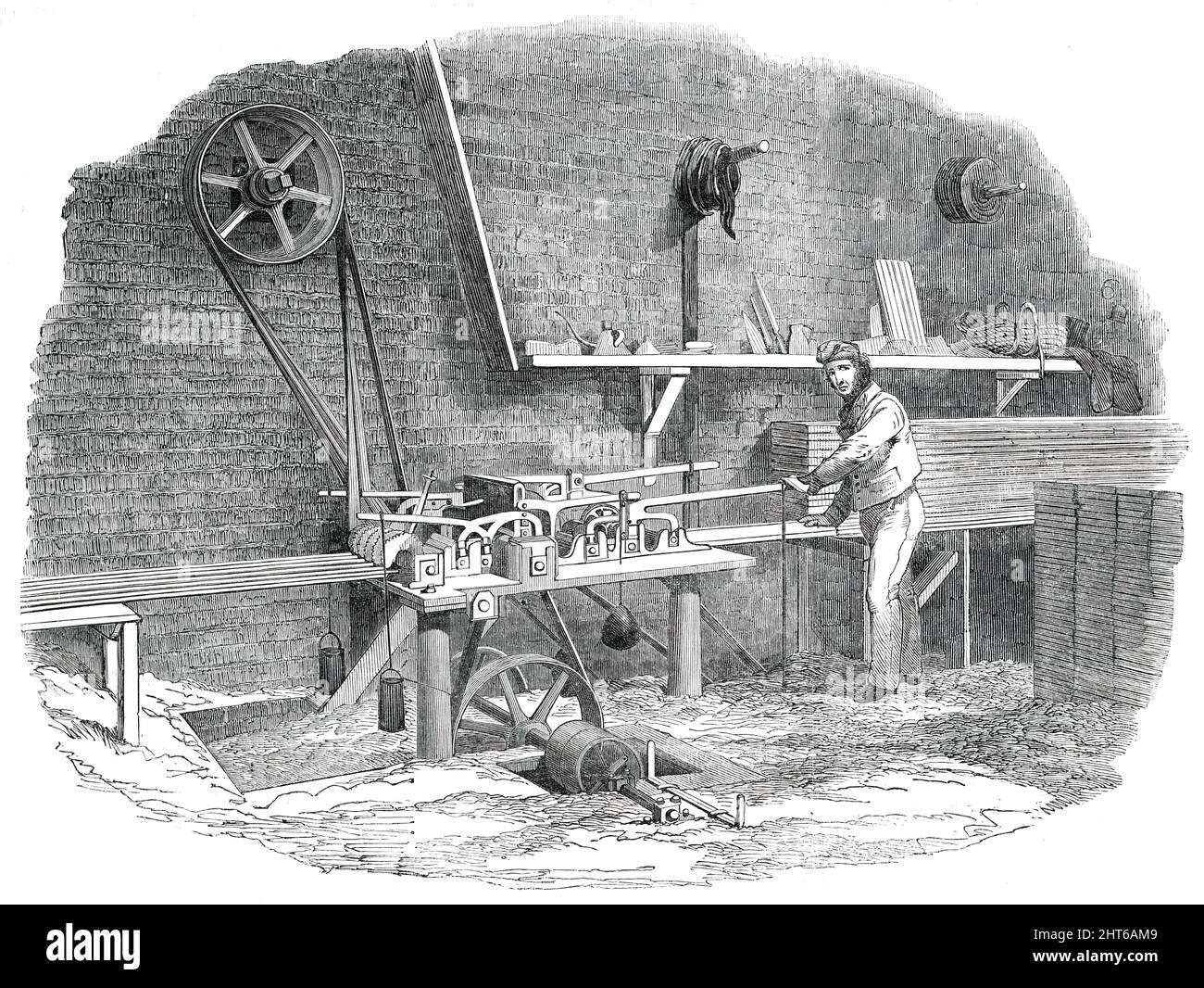 The Sash-Bar Machine, for the Great Exhibition Building, in Hyde Park, 1850. '...we find a communication from Mr. Paxton on this subject, dated 13th March, 1840, in which he says that, in its first state, it merely performed the part of a grooving-machine, but was subsequently improved so as to make the bar complete and that, by its adoption, the labour of twenty men for one year was performed, and a consequent saving of &#xa3;1200 effected in labour alone. Now, we are not aware of sash-bars being completed by machinery before this period; and in the machine represented in the View, we perceiv Stock Photo