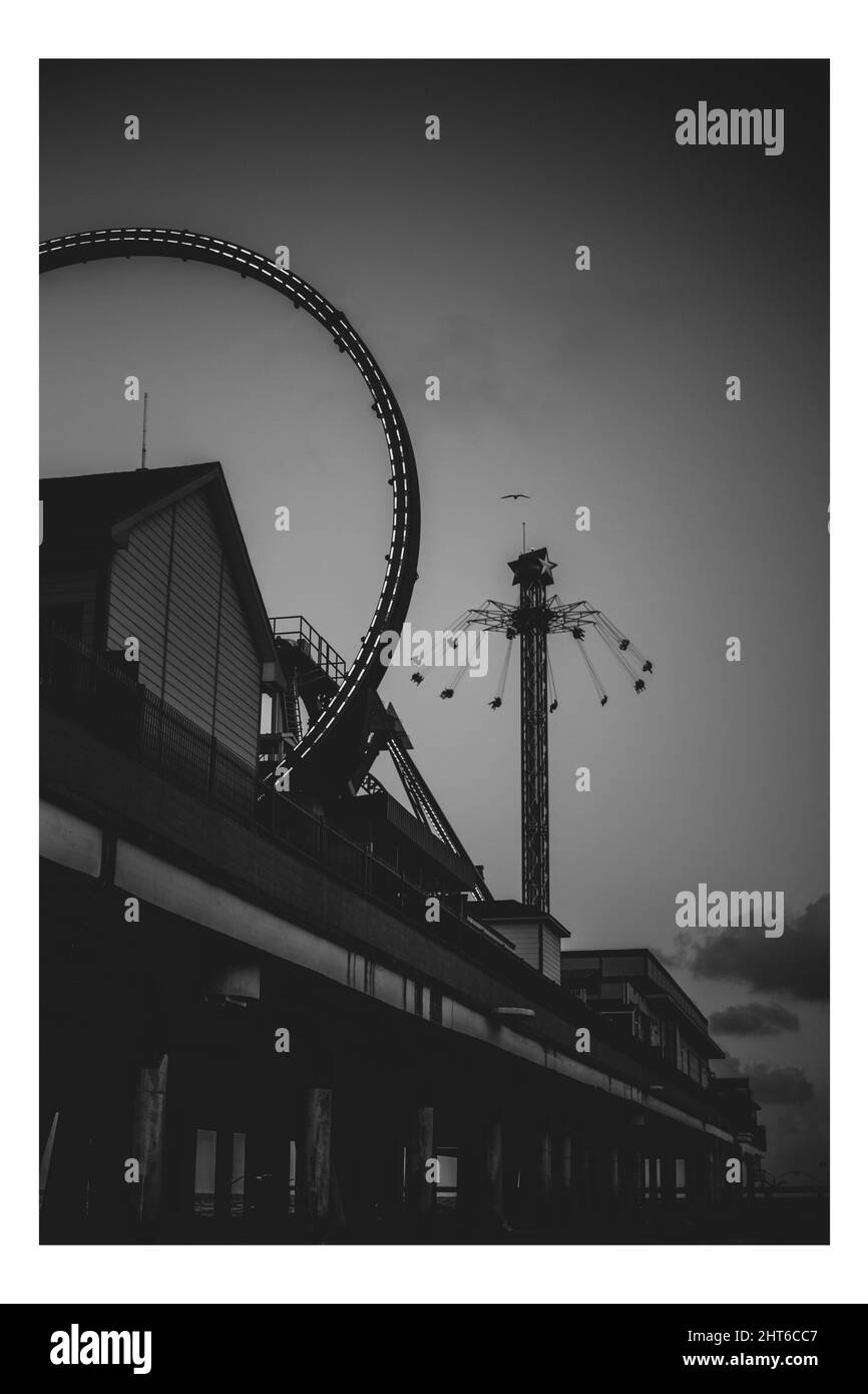 Grayscale shot of the amusement park on a gloomy day near the Galveston beach Stock Photo