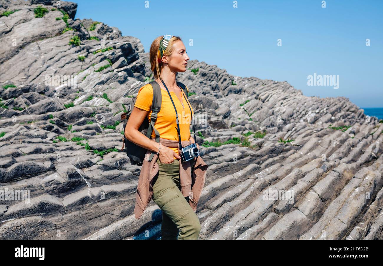 Hiking woman watching flysch rocks landscape Stock Photo