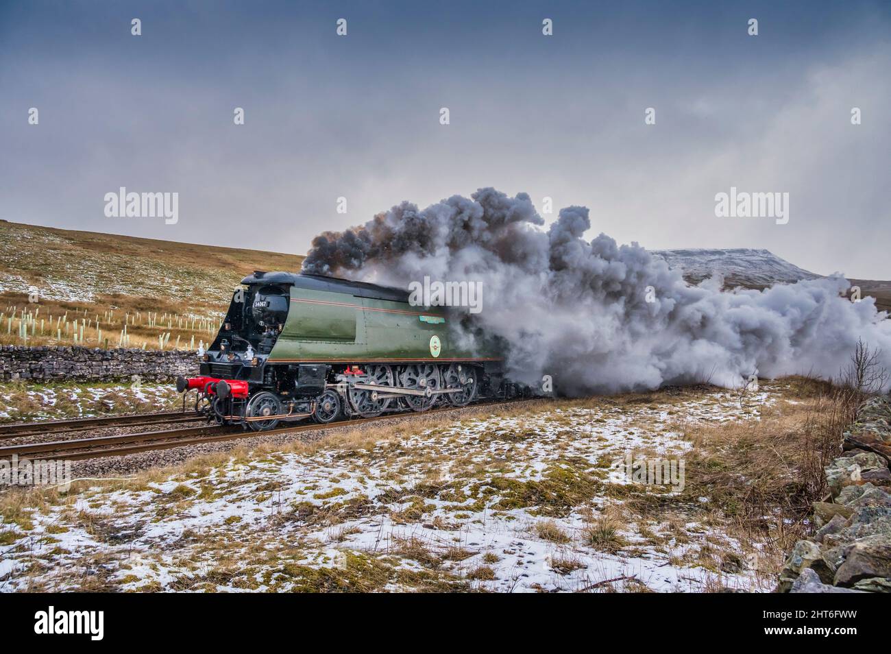 The image is of the Southern Railways Battle of Britain Class 4-6-2 #34067 Tangmere approaching Ais Gill summit on the Settle to Carlisle line in the Stock Photo