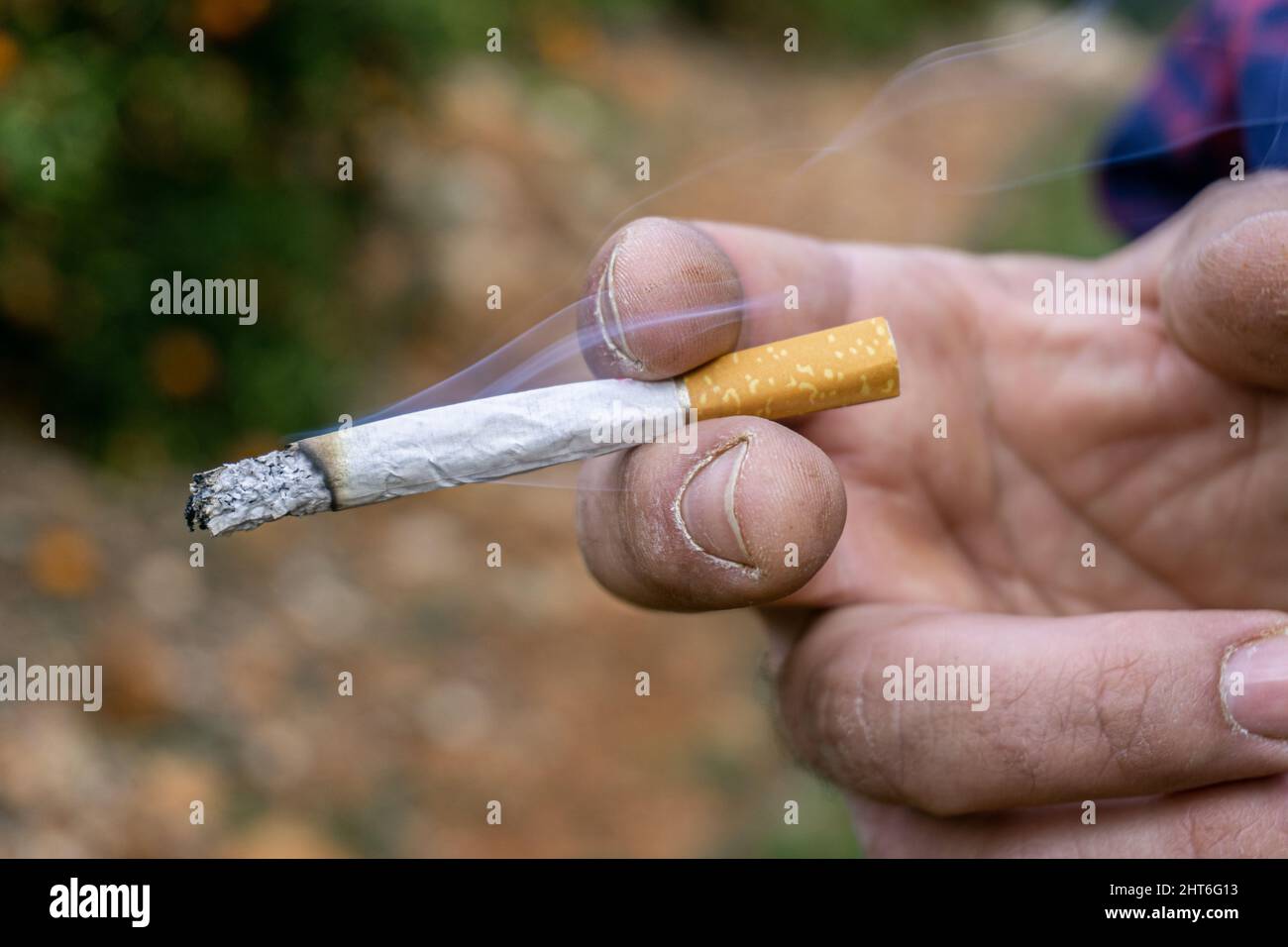 Holding cigarette between fingers hi-res stock photography and images