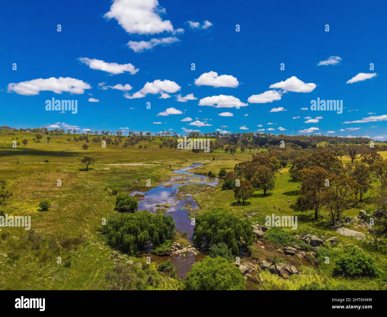 Aerial view of green lands, trees, and the Mann River near Glen Innes