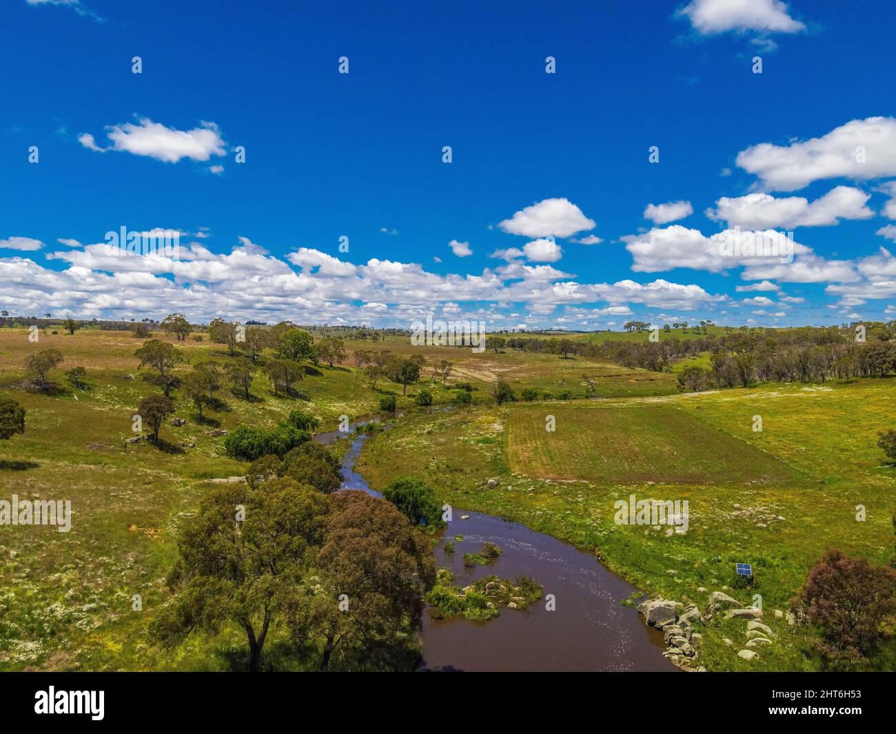Aerial view of green lands, trees, and the Mann River near Glen Innes
