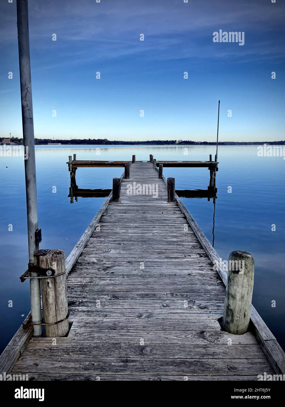 Vertical shot of an old pier under the clear skies Stock Photo - Alamy