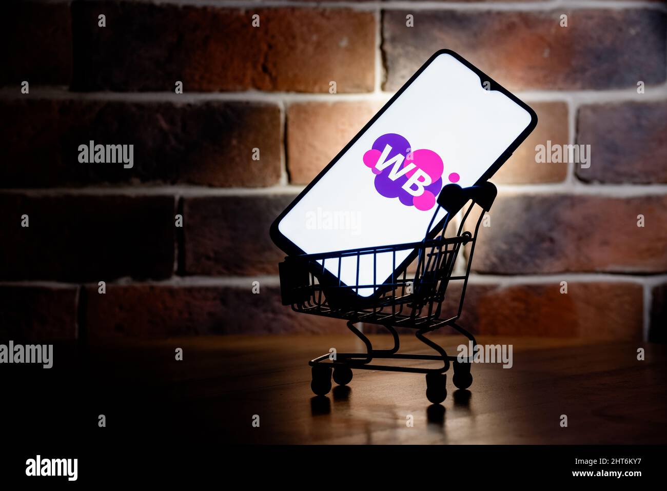 Wildberries is one of largest Russian online retailer. Smartphone with Wildberries logo on screen in the shopping cart. Stock Photo