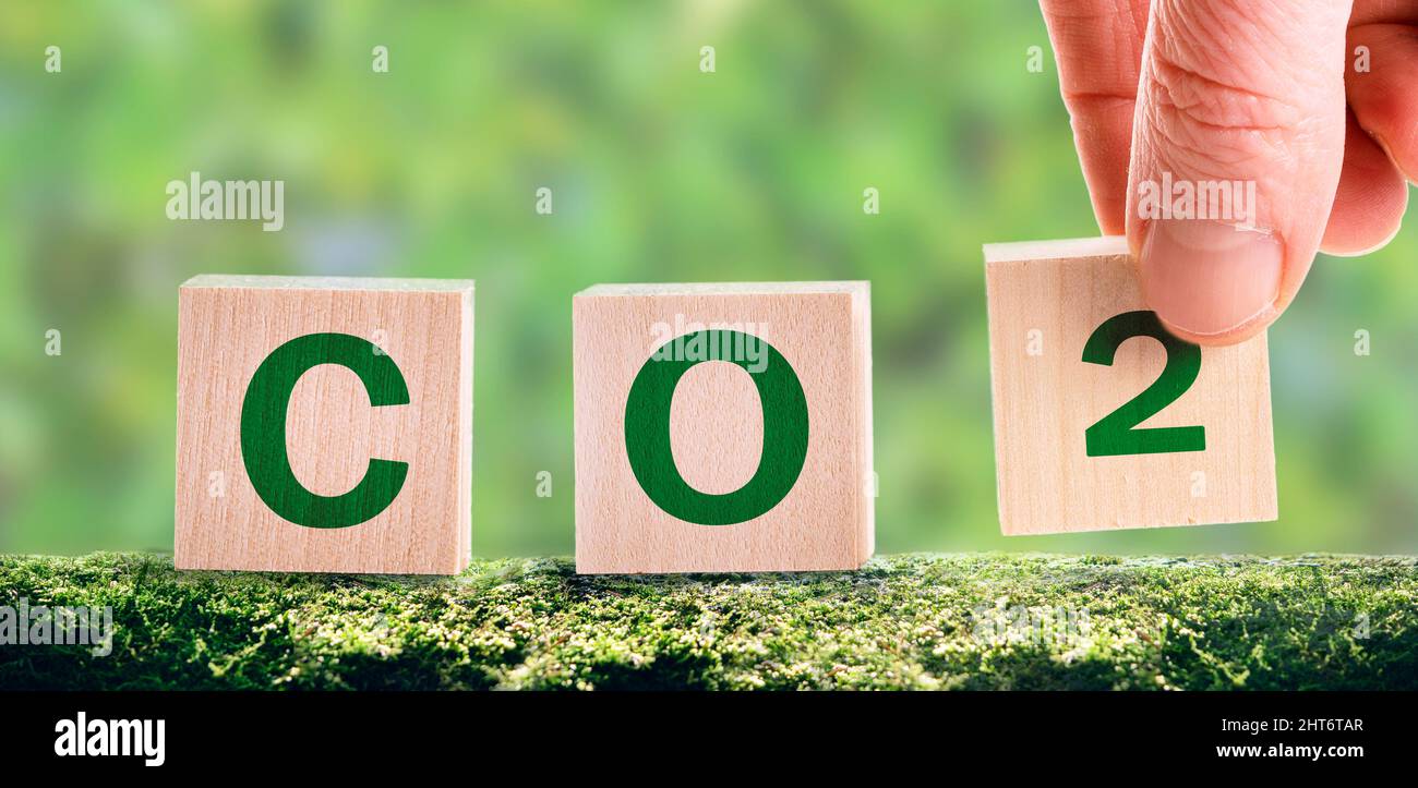 CO2 cubes on a green background, the concept of energy saving and emission reduction. .New technology to decarbonize industry, energy and transport Stock Photo