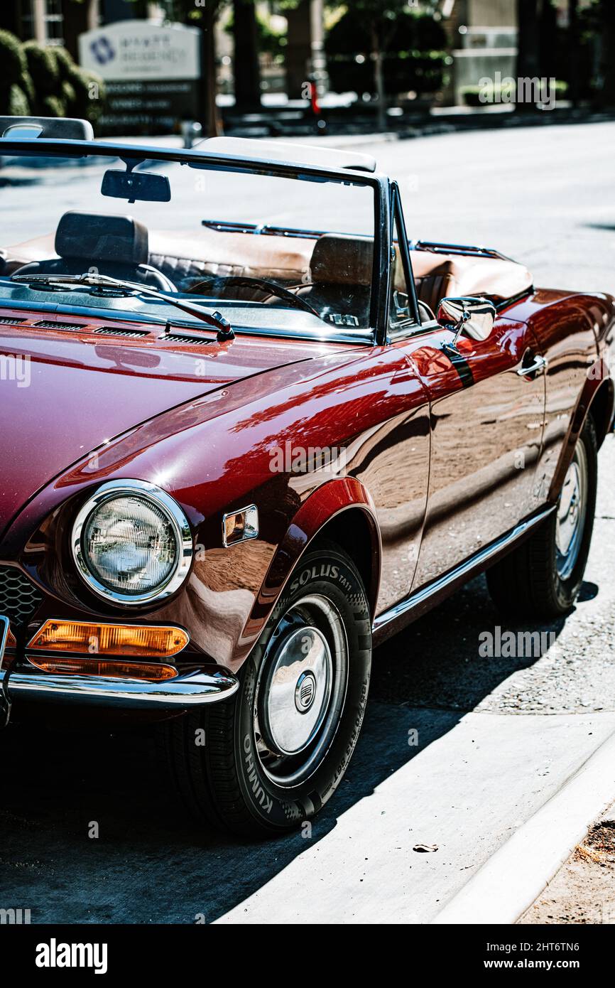 Beautiful red vintage convertible car parked on the street in ...