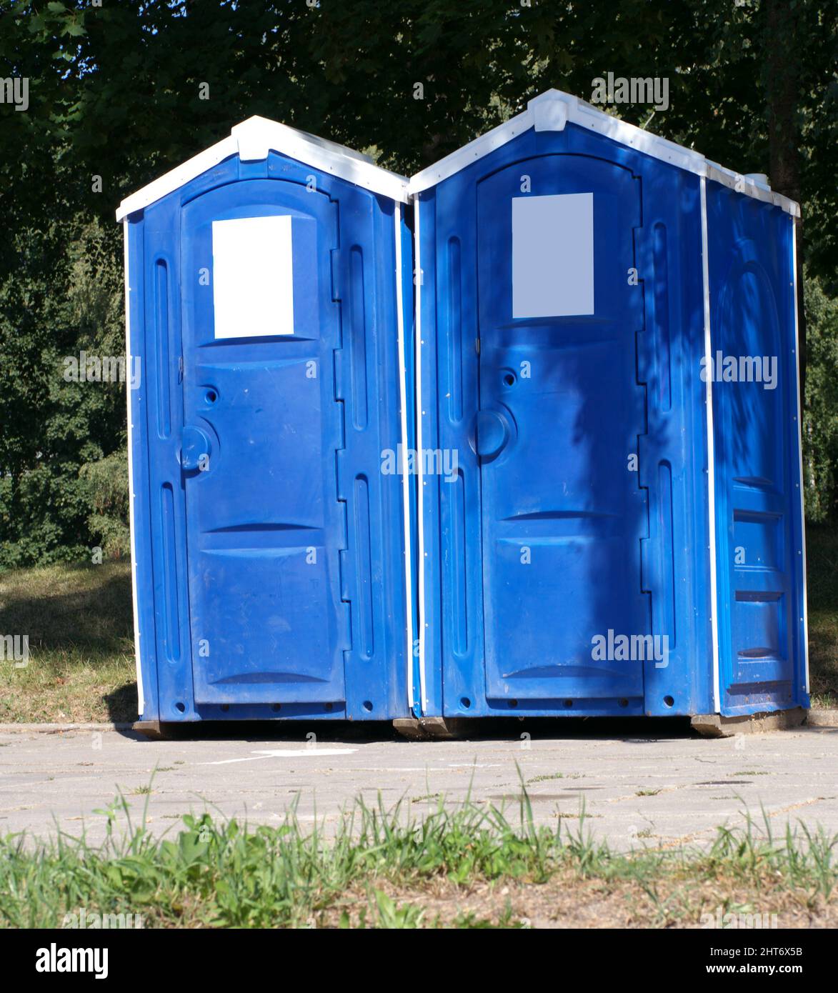 Two portable toilet cabins in park at dry sunny summer day Stock Photo -  Alamy